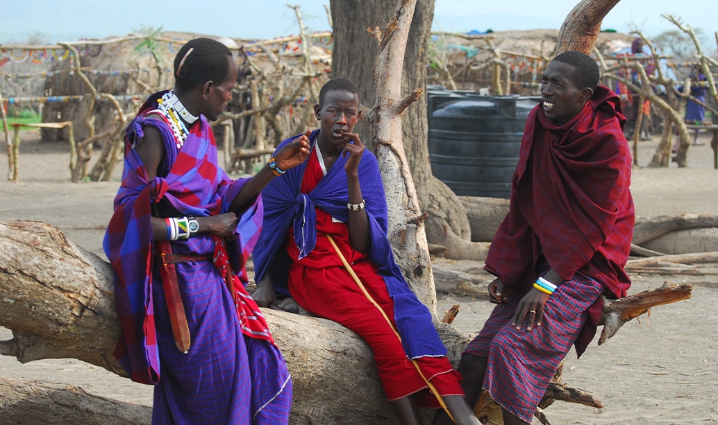 Maasai warriors moving through the bush in a group during the day