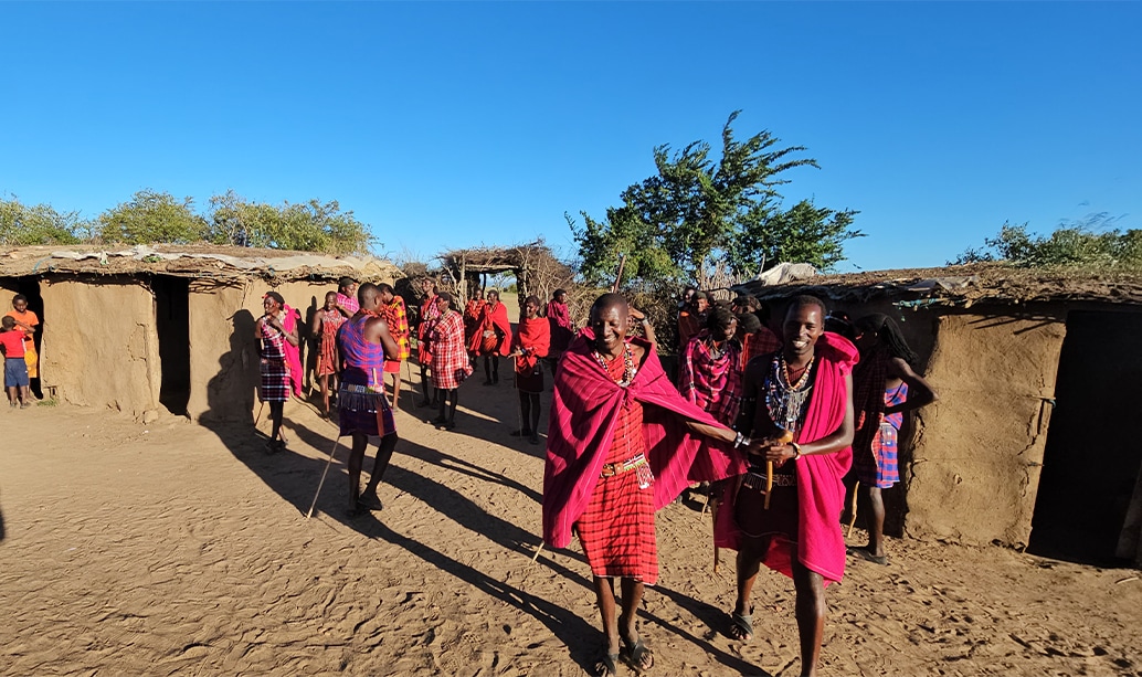 Visitors being welcomed into a Maasai homestead